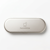DentraWhite silver travel tin for storing stainless steel tongue scraper tools on a white background