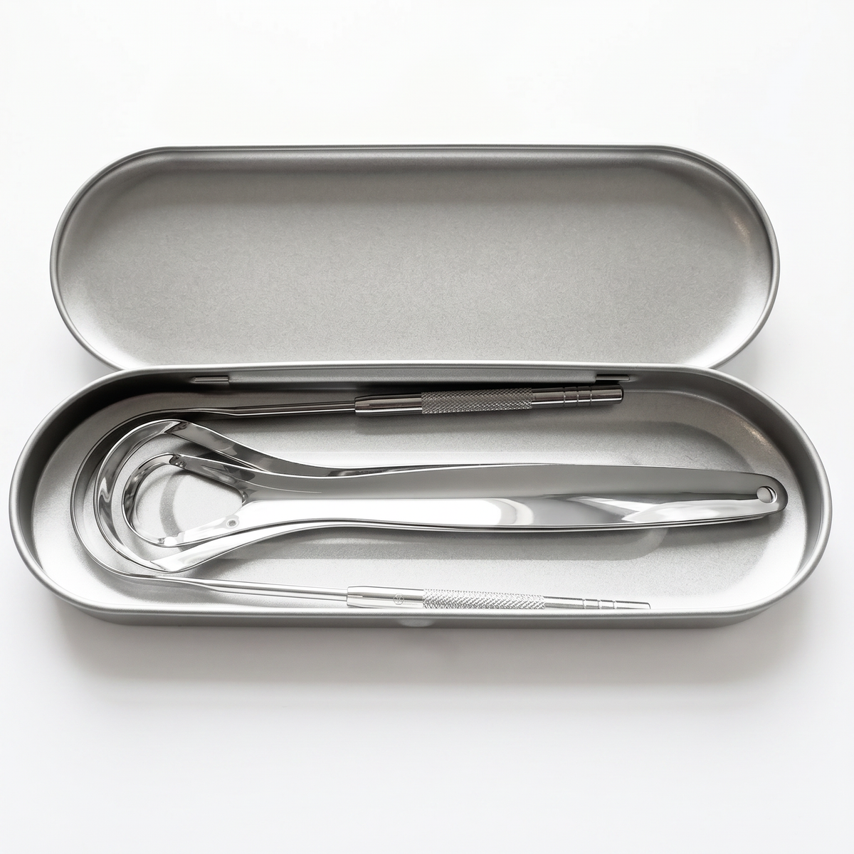 DentraWhite stainless steel tongue scraper tools stored inside an open silver travel tin